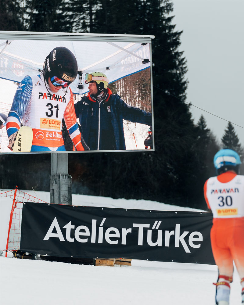 Para-Weltcup Feldberg Videodisplay LED Sponsorenbanner Atelier Türke Videodisplay mit Livebild und gebrandetem Banner von Atelier Türke beim FIS Para Weltcup. Digitale Markenpräsenz und Inszenierung realisiert von Atelier Türke.